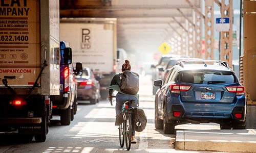 Commute Man riding his bike down the street